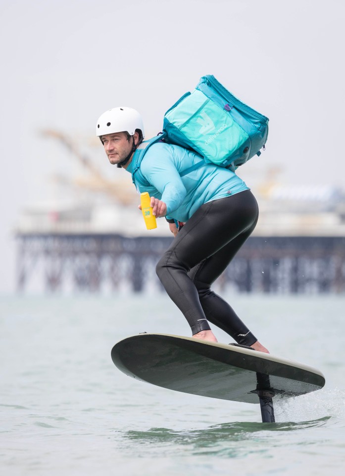 a man riding a surfboard with a bag on his back