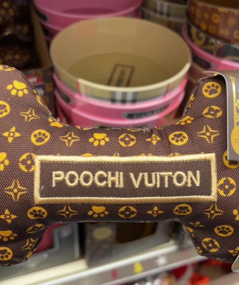 a dog bone that says poochi vuitton on it