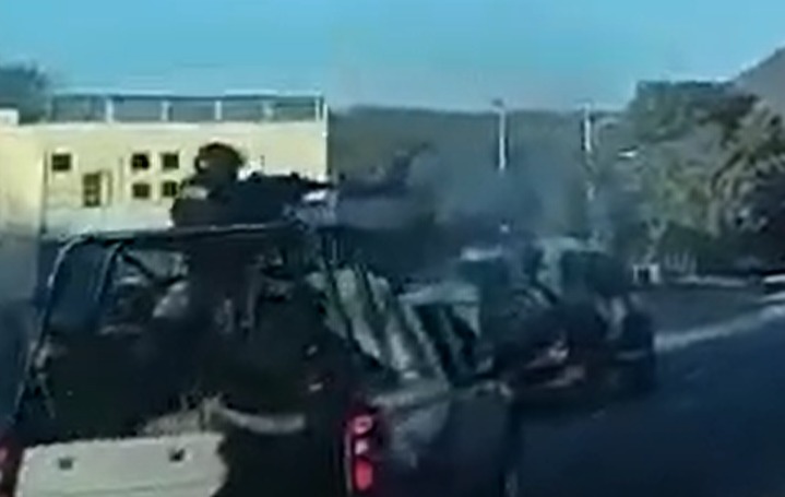 Cops locked in a firefight as they drive down a road