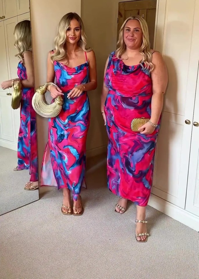 two women are standing next to each other in front of a mirror