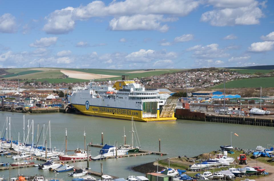 a large yellow and white ship with the website www.transandferries.co.uk on the side