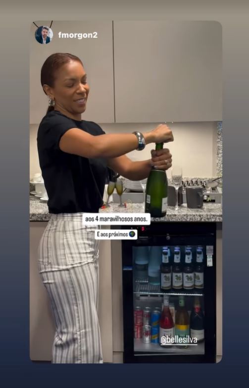 a woman is pouring a bottle of champagne into a glass