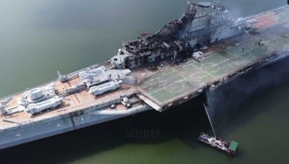 an aerial view of a large military ship in the water .