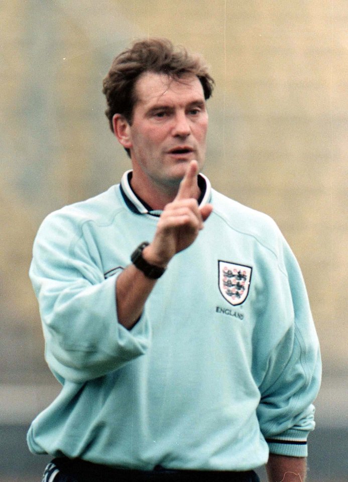 a man wearing a light blue england shirt giving a thumbs up