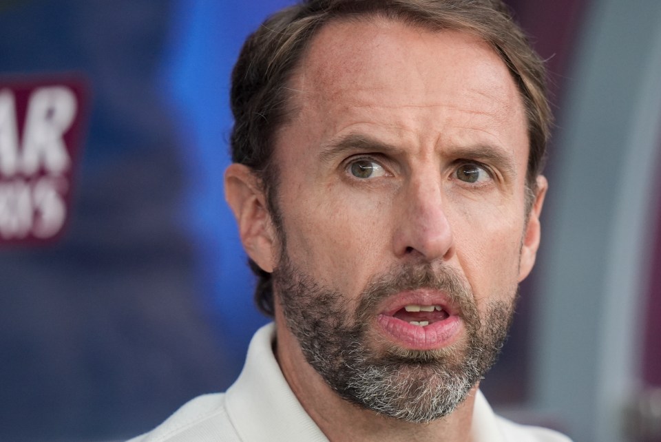 a man with a beard and a white shirt looks at the camera