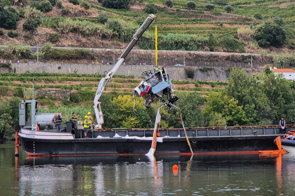 a crane is lifting a car from the water