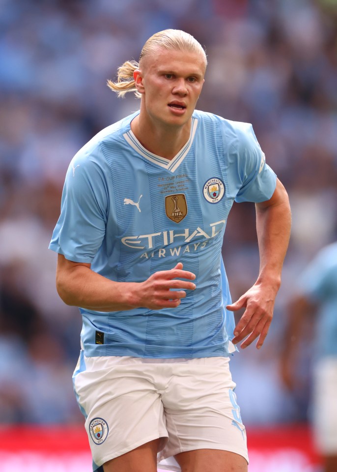 a soccer player wearing a blue shirt that says etihad airways