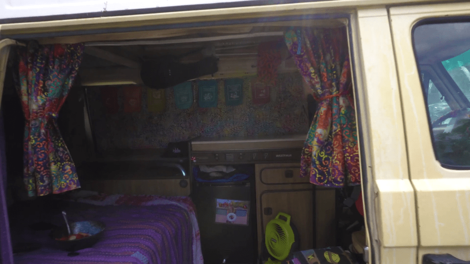 the inside of a van with a sticker on the trash can that says ' recycle '