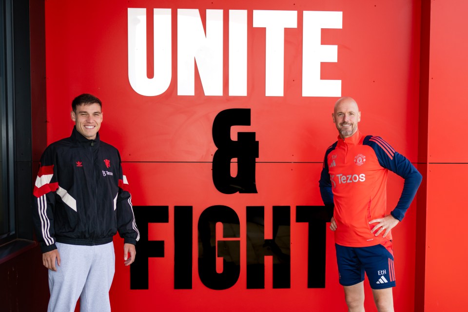 two men stand in front of a sign that says unite & fight