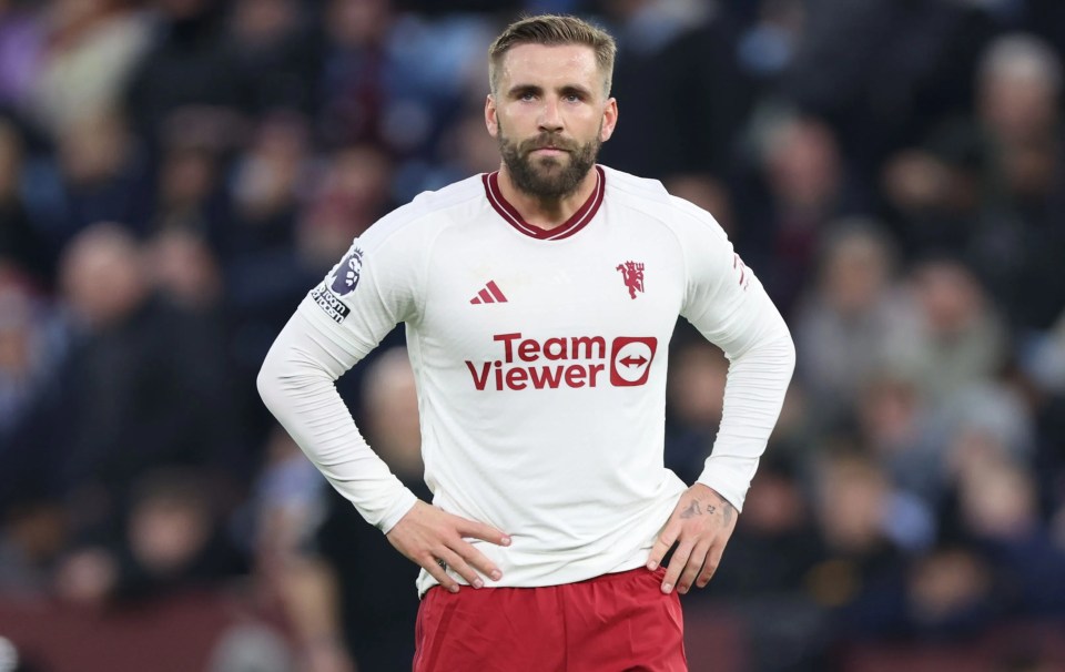 a man with a beard wears a white team viewer jersey