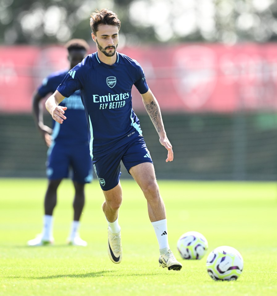 a soccer player wearing a shirt that says emirates fly better