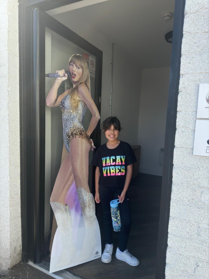 Alice, nine, posing next to a cutout of Taylor Swift moments before horror attack