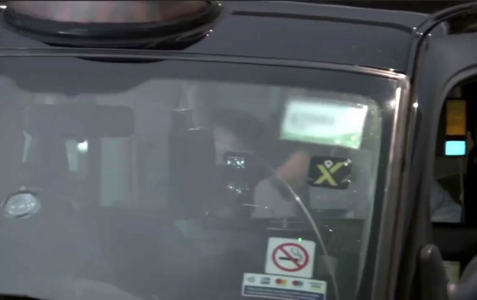 The couple inside their 'fake taxi', which circled the block before kicking them out