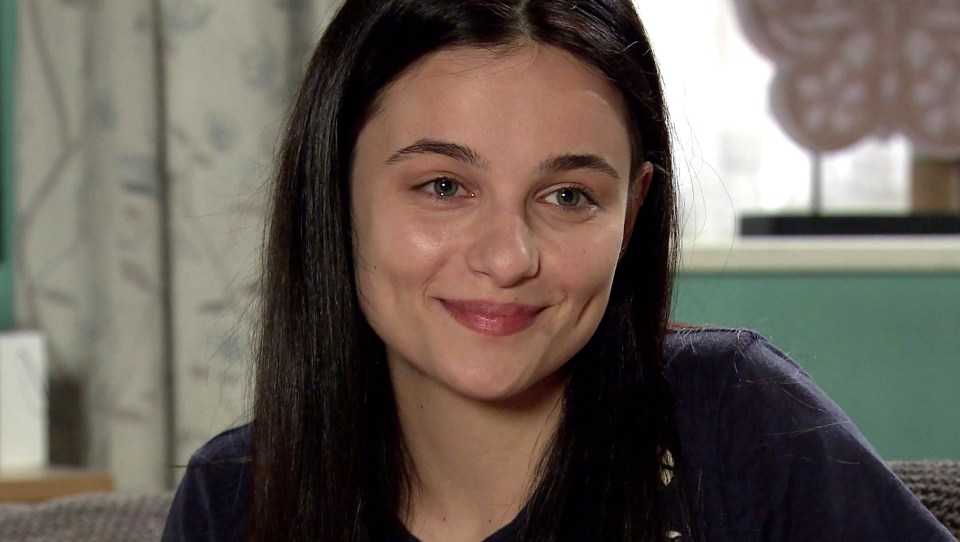 a close up of a woman 's face with a smile on her face