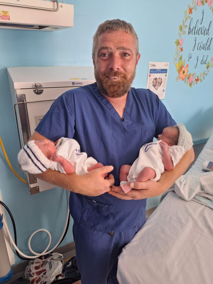 A tearful Matt Whittaker, 36, holding twin boys Noah and Abel