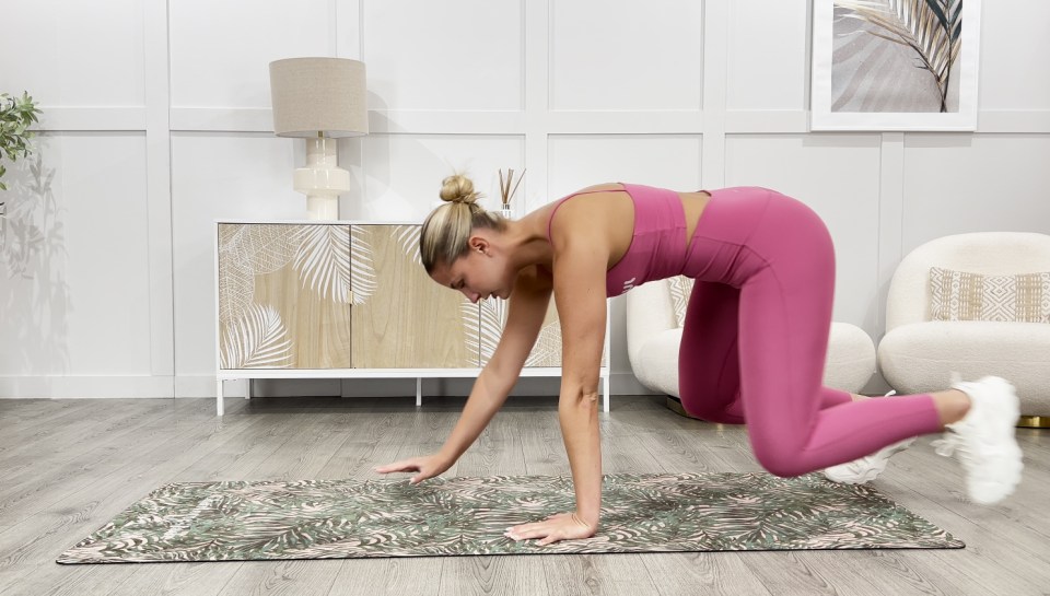 a woman in a pink top and leggings is doing exercises on a yoga mat