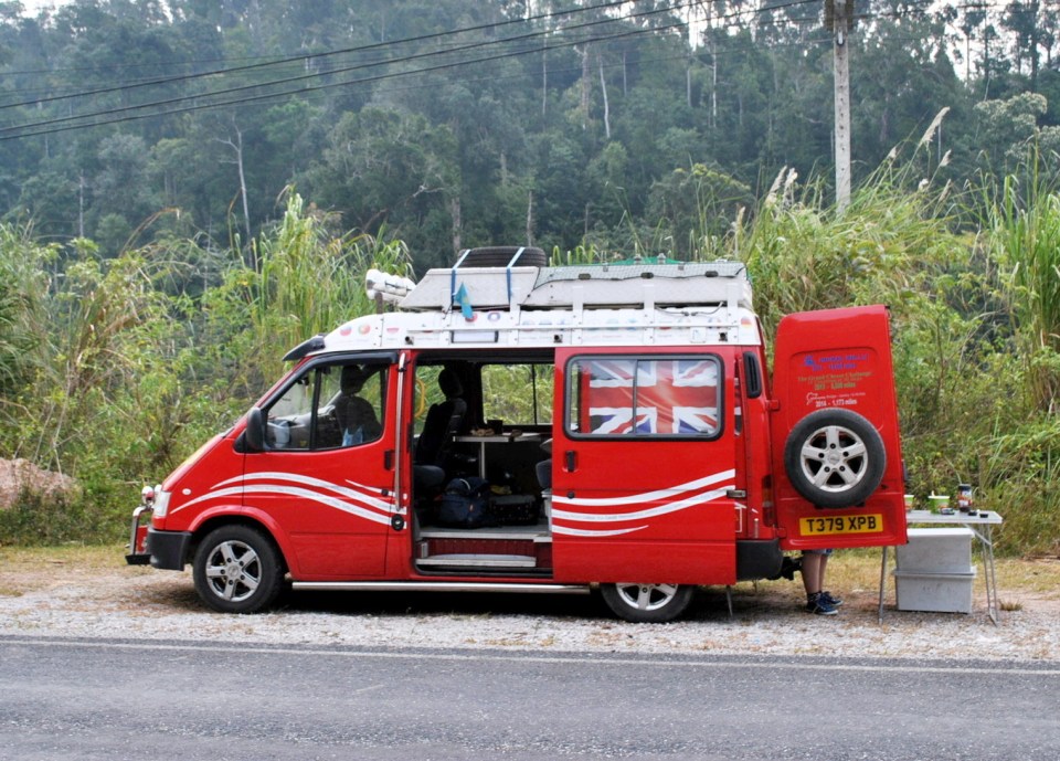 He converted the bright red motor into a mini home on wheels