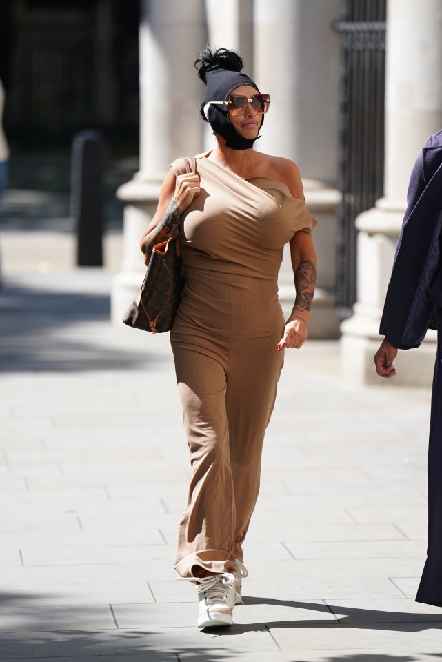 a woman with a bandage on her head walks down the street