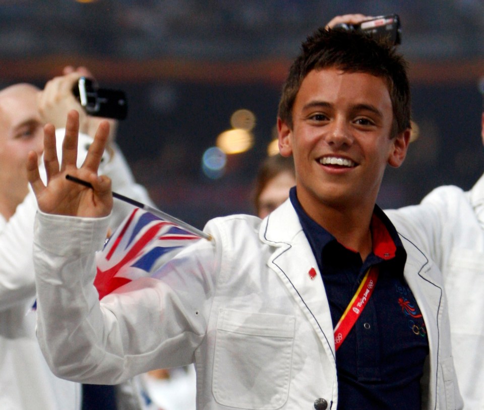 a young man wearing a jacket that says ' london 2012 ' on it