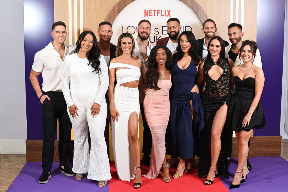 a group of people standing in front of a sign that says netflix