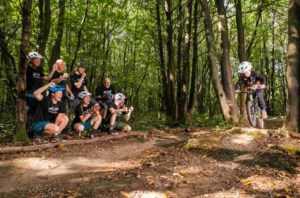 a group of people with one wearing a shirt that says mtb