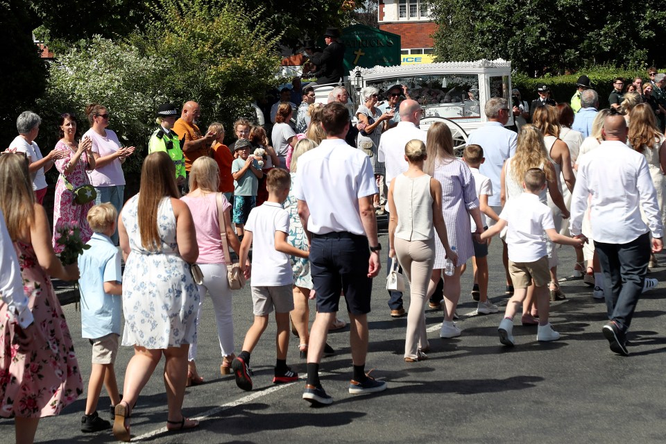 The funeral cortege, dressed in white, has arrived