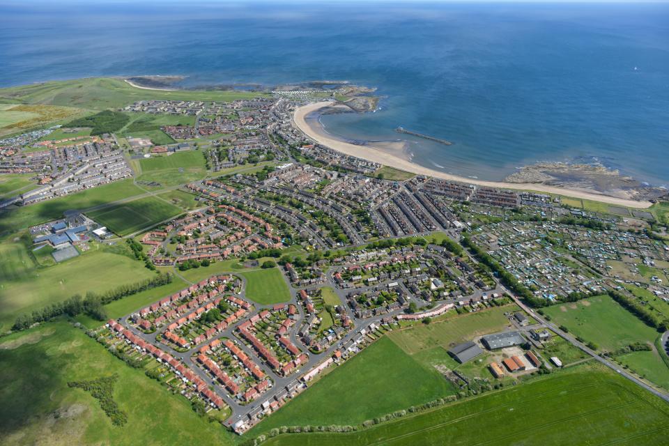 an aerial view of a residential area near the ocean