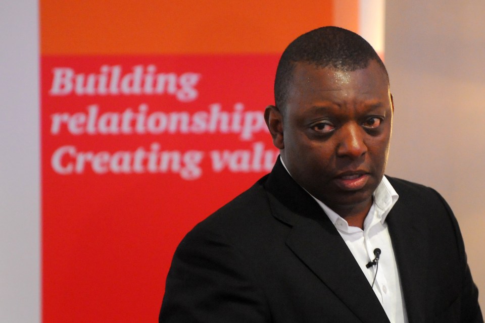 a man stands in front of a sign that says building relationship creating value