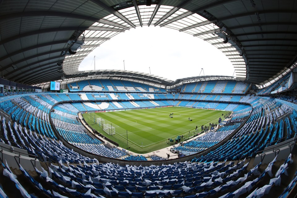 an empty soccer stadium with the word city on the field