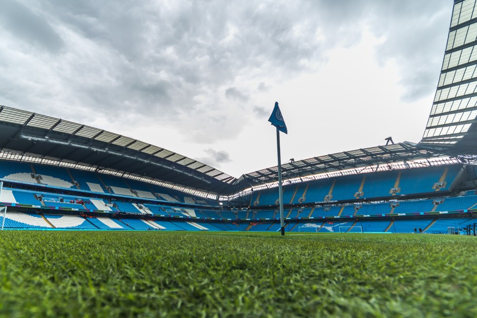 a blue and white stadium with a flag in the middle