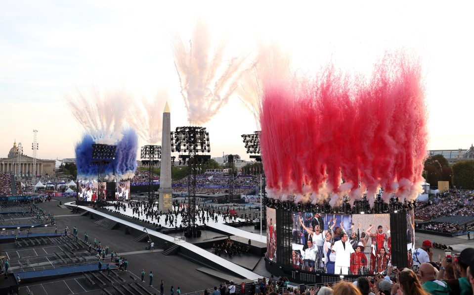 red white and blue fireworks are being displayed in a stadium