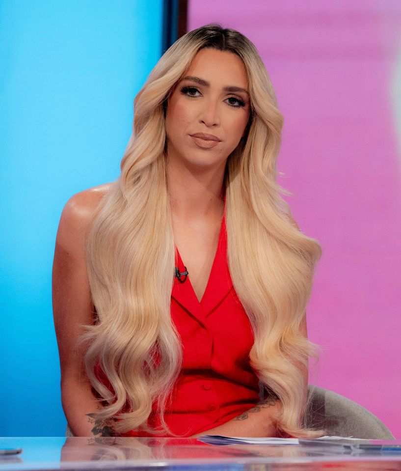 a woman with long blonde hair is sitting at a desk