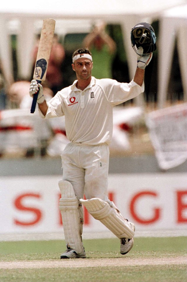 a cricket player holds up his bat in front of a sign that says spice