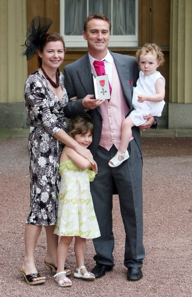 Thorpe accepting his MBE in 2007 with wife Amanda, daughter Emma and step-daughter Kitty