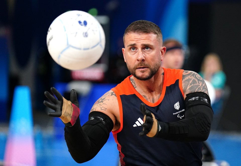 a man wearing a shirt that says ' paralympics ' on it