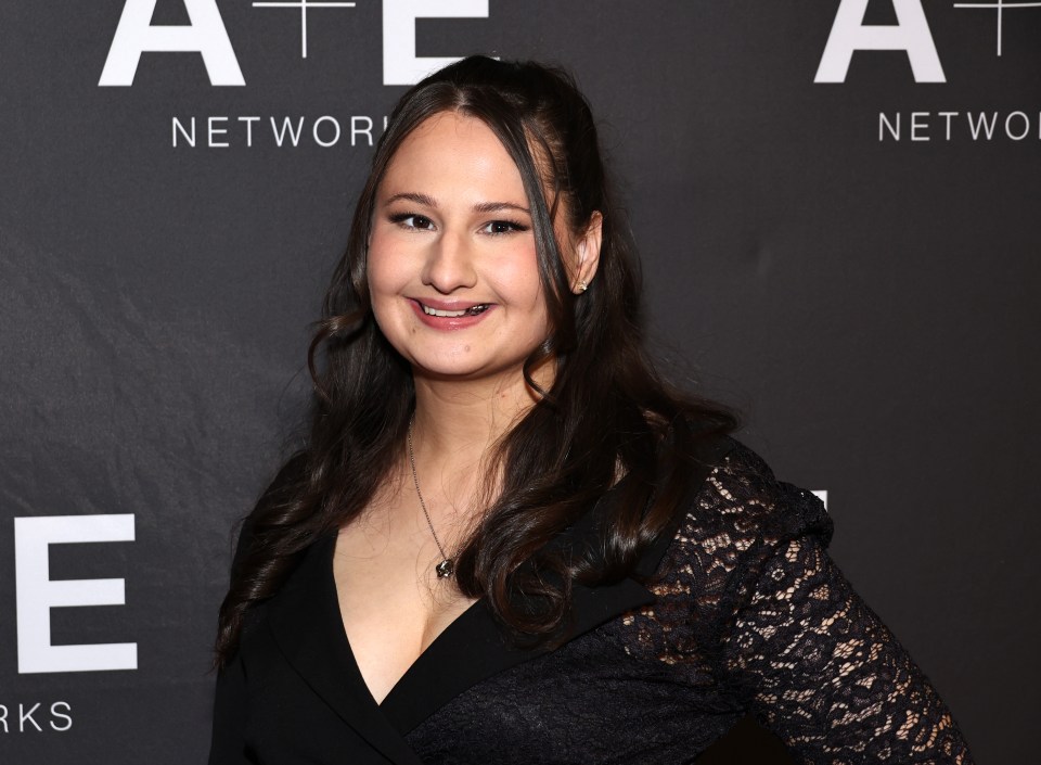 a woman stands in front of a sign that says ate network