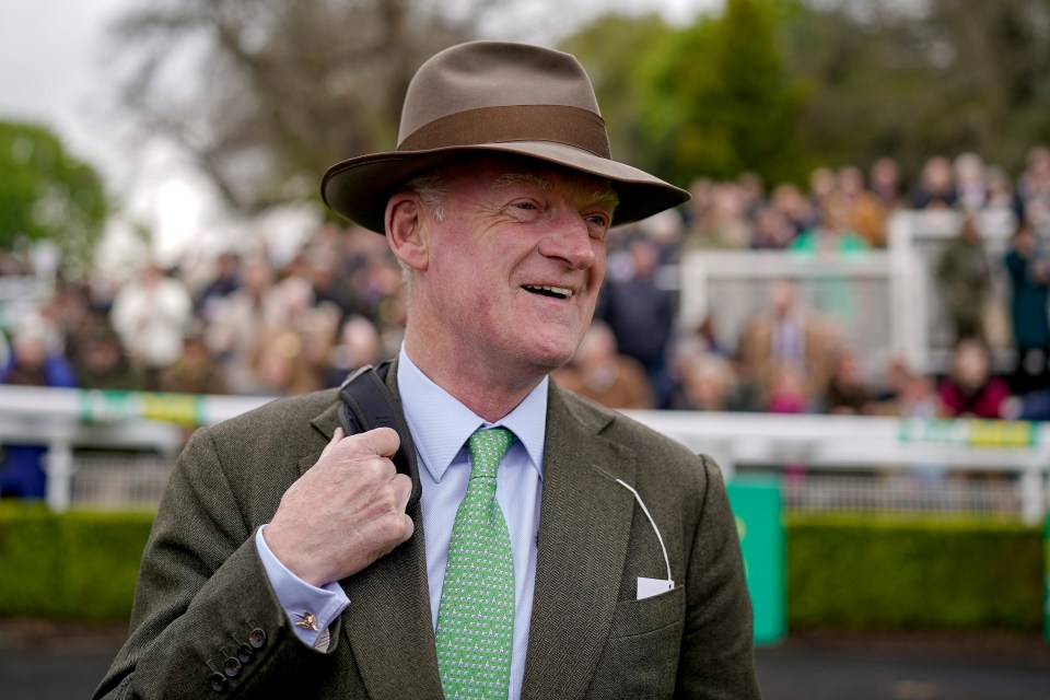 a man wearing a hat and a green tie smiles