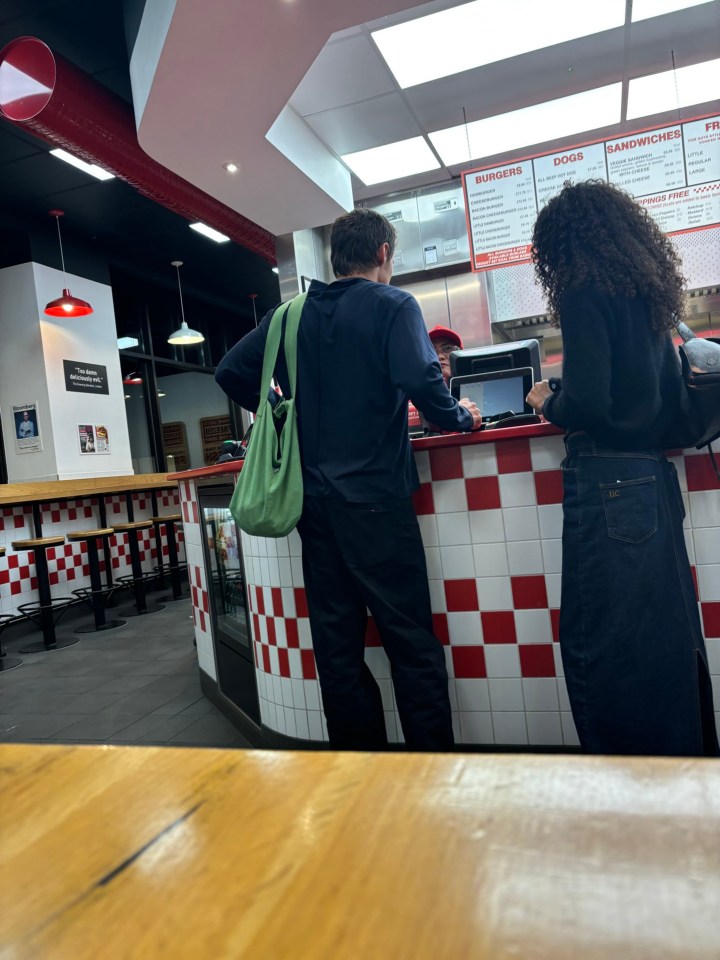 Harry Styles and Olivia dean pictured in a Five Guys restaurant