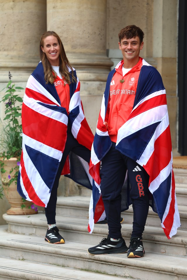 Team GB’s Helen Glover and Tom Daley proudly drape themselves in Union Jack flags