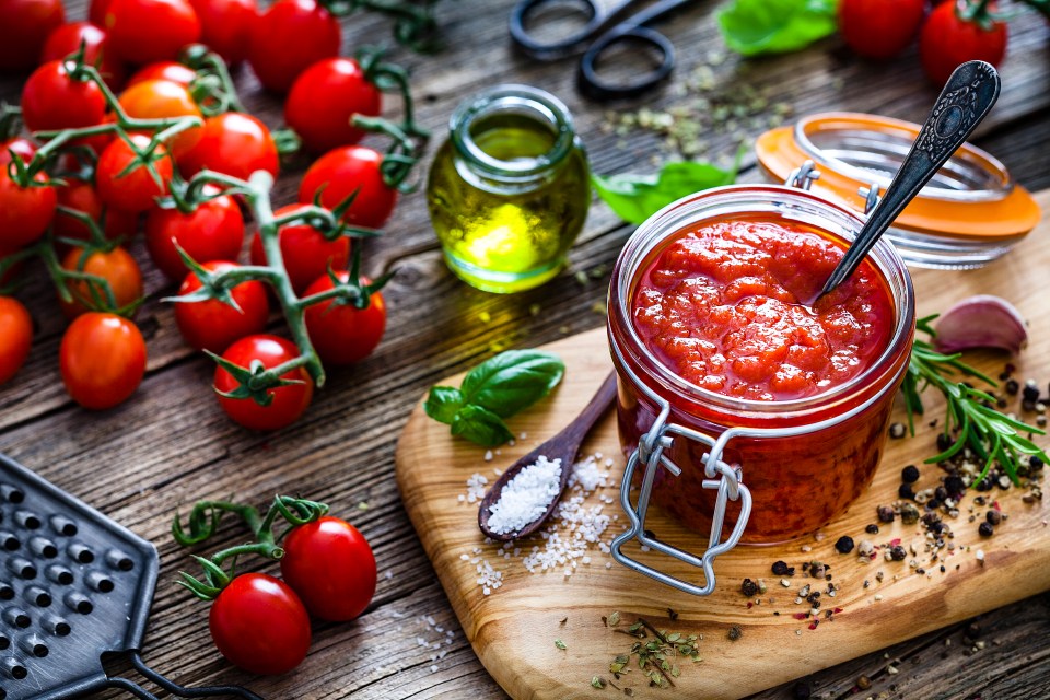 a jar of tomato sauce with a spoon in it