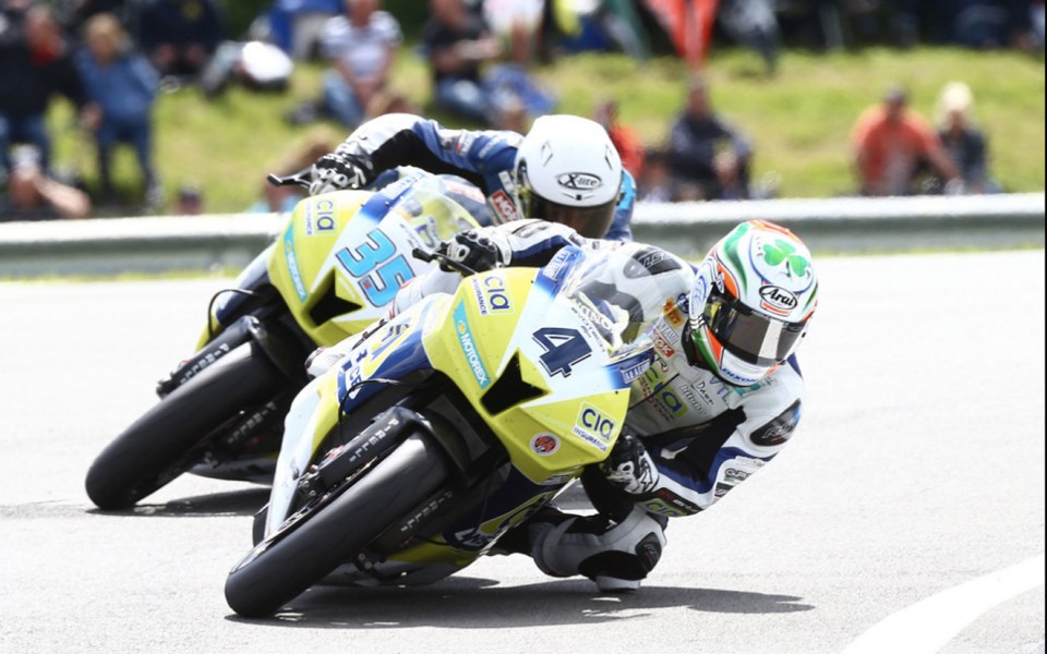 a motorcycle racer wearing a helmet with the number 4 on it