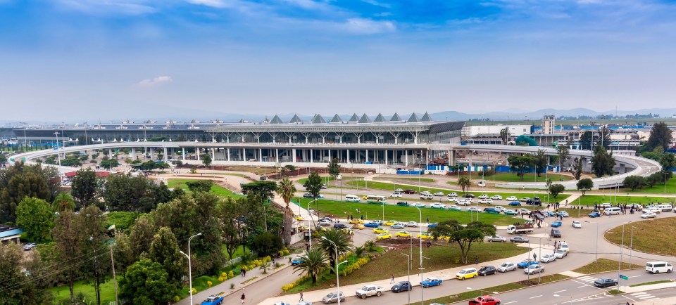 a large building with a lot of cars parked in front of it