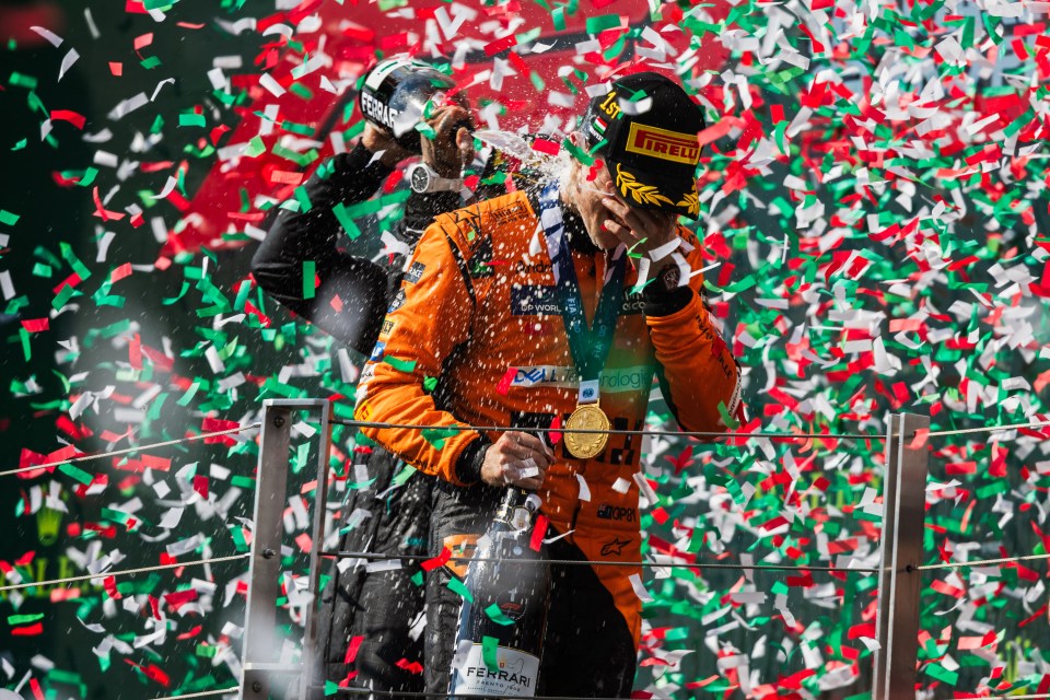 a man wearing an irelli hat is holding a bottle of champagne