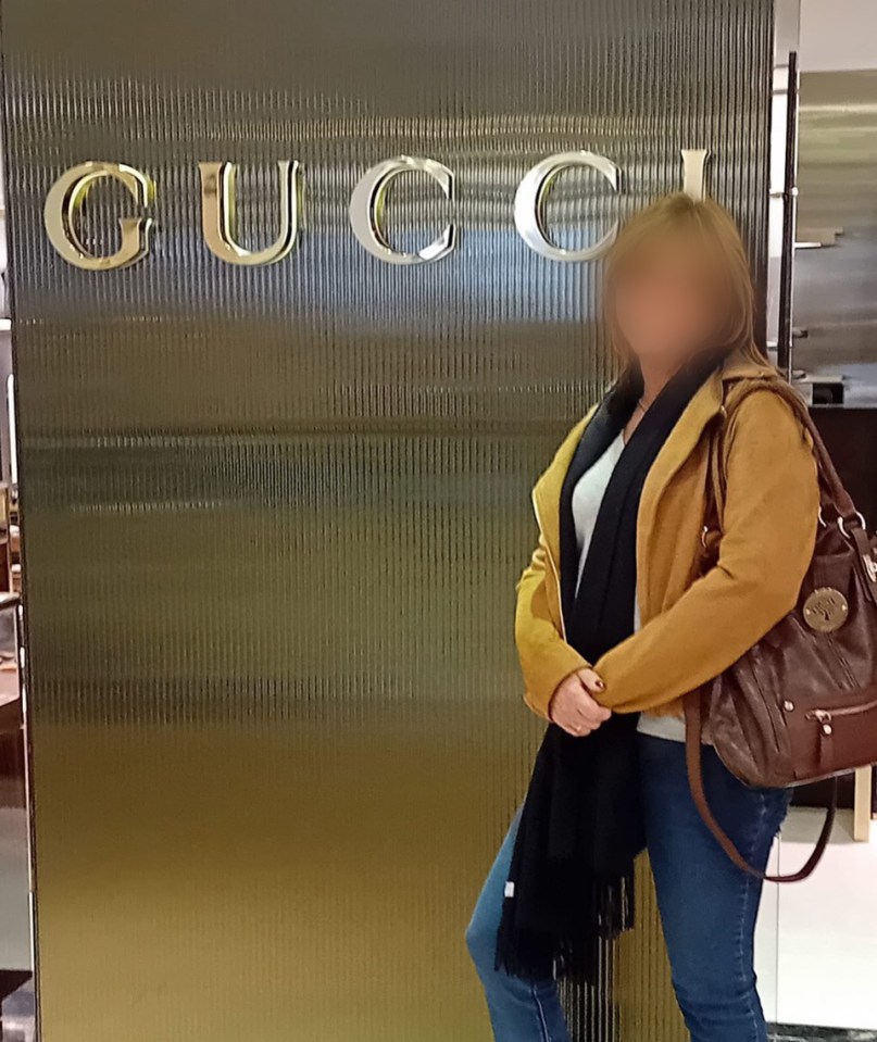 a woman stands in front of a gucci sign