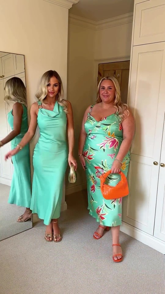 two women in green dresses are standing next to each other