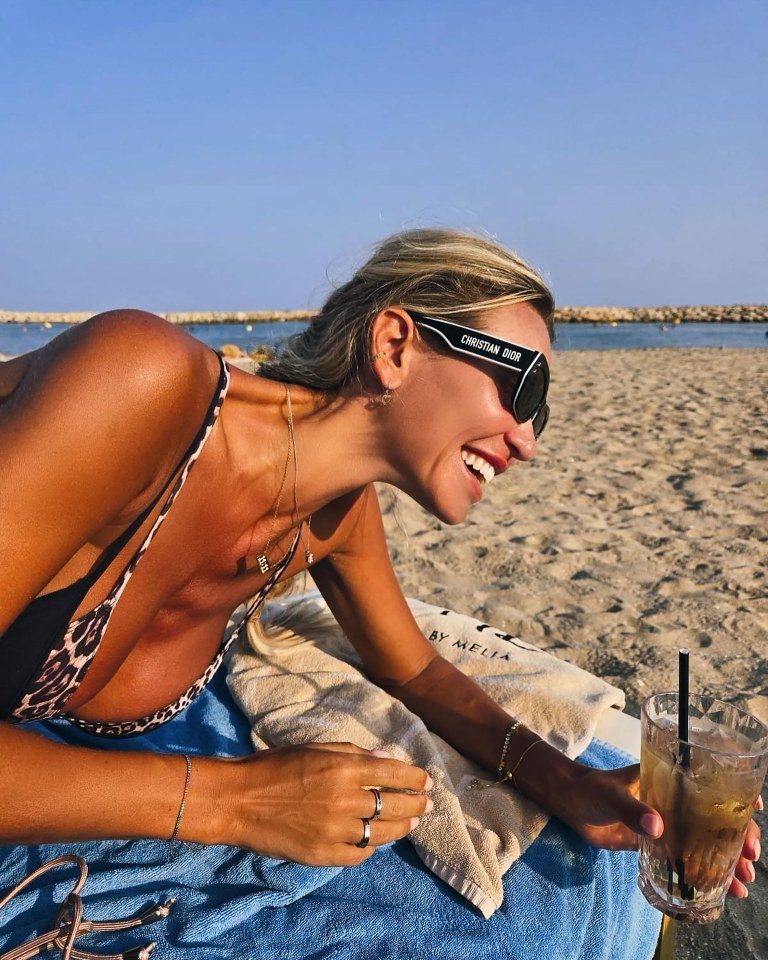 Christine posed on the beach as she enjoyed a cocktail under the sun