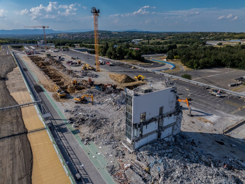 an aerial view of a construction site with a building being demolished