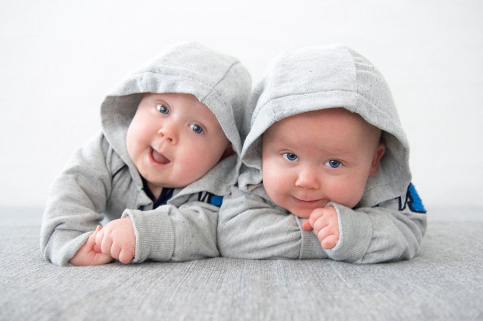 two babies wearing hoodies with the letter a on them