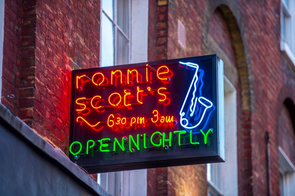 a neon sign for ronnie scott 's open nightly