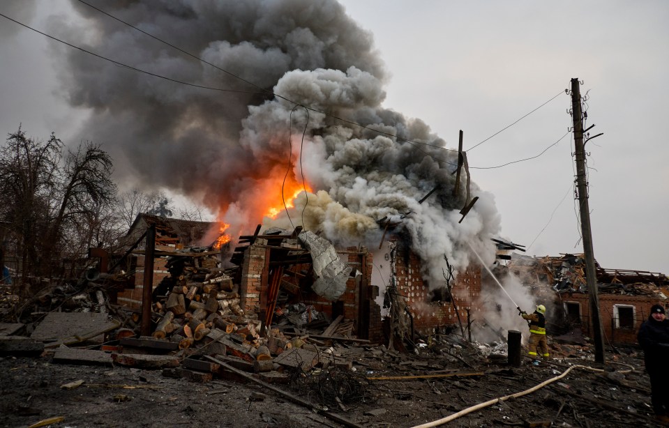 Rescuers scramble to find survivors after a rocket attack in Kharkiv